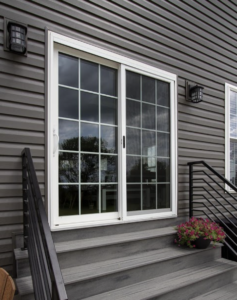 Sliding patio doors on a house with grey siding