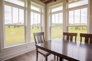 A beautiful view outside a vinyl window installed in a dining room 