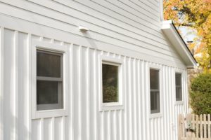 Home with windows and white fiber cement siding 